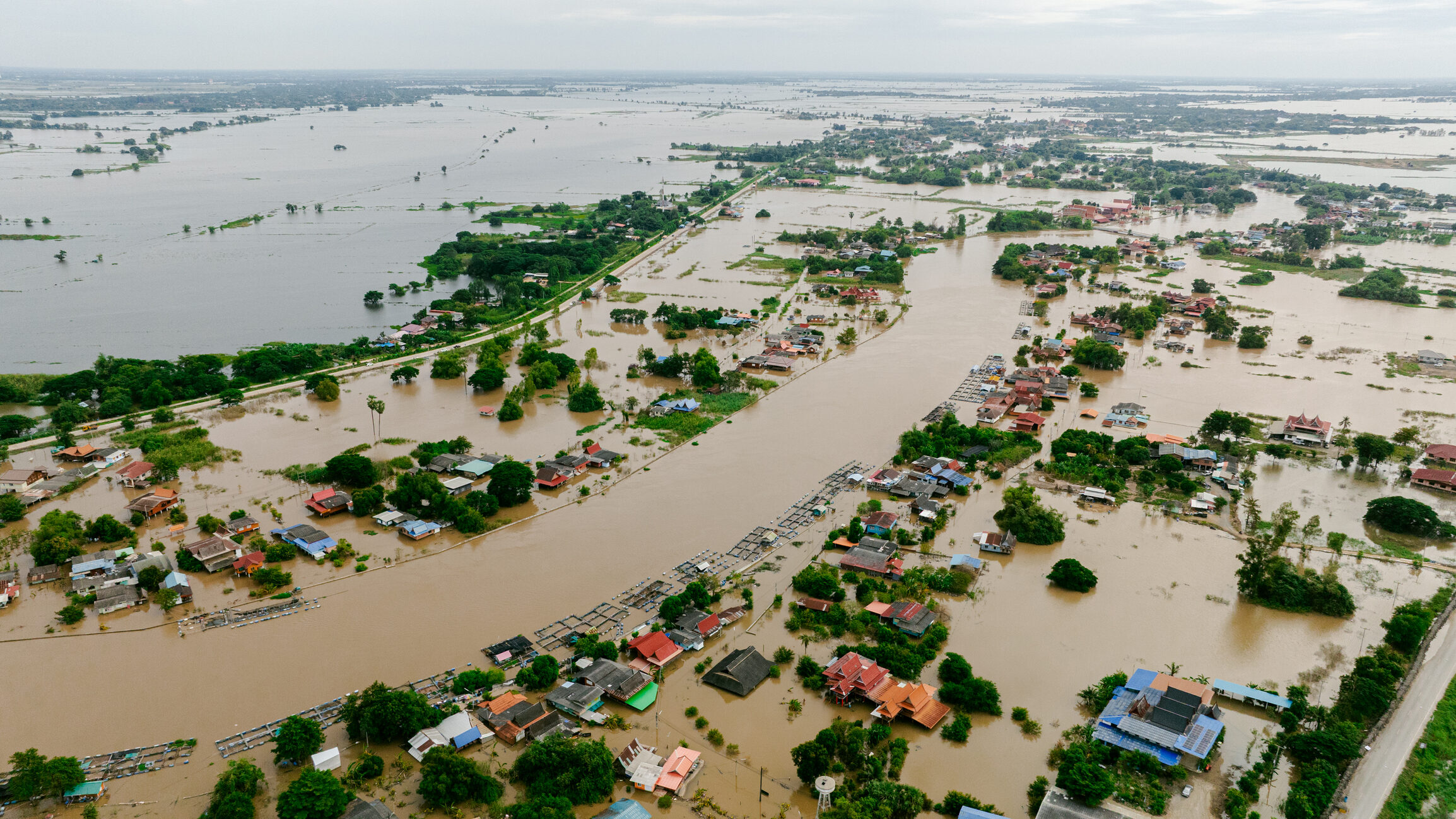 Flooded area shows water covering homes and roads during a natural disaster event in the local community